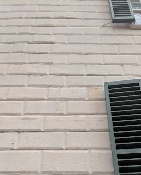 The Mansion with pounded sandstone thrown on the wet paint.