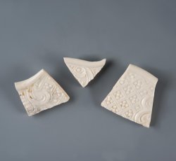 White salt glaze stoneware dot, diaper, and basket molded plate or dish with scalloped edge.