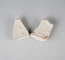 White salt glaze stoneware dot, diaper, and basket molded plate.