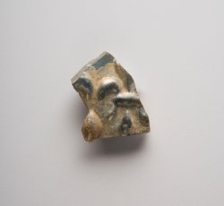 Light blue hollow ware glass with fleur de lis design.