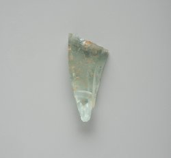 Molded unidentifiable aqua glass bottle.