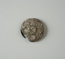 Silver-alloy plated copper alloy button face with stamped floral and geometric design.