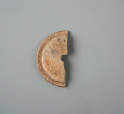 Carved bone coat button back with beveled edge and one eye.