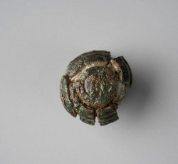 Copper alloy domed collar button with concentric ring design.