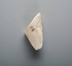 Tobacco pipe bowl fragment with partial stamped cartouche and W[?]. 