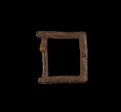 Small copper alloy single frame strap buckle.