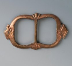 Double frame copper alloy strap buckle with lozenge and trefoil decoration.