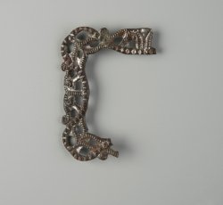 Copper alloy shoe buckle with openwork decoration and silver wash.