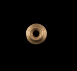 Circular copper alloy leather ornament with 2 tines.