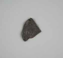 Quartered white metal coin.