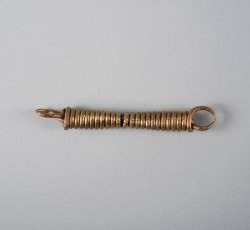 Coiled copper alloy jewelry wire with suspension loop at each end.