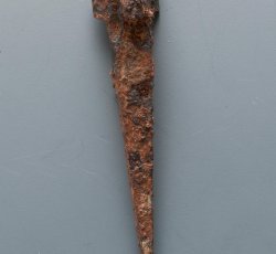 Triangle-head nail with pointed tip.
