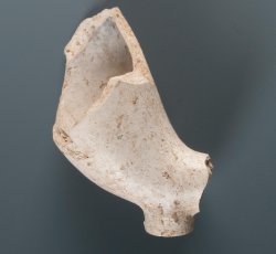 Tobacco pipe bowl and base with the initials "T" and "D" molded on either side of the heel. 