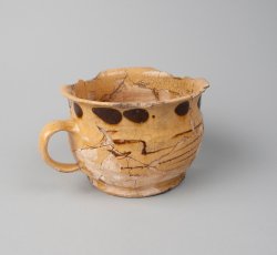 Staffordshire slipware trailed, combed, and dotted drinking pot.