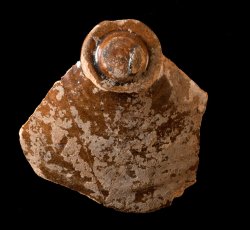 Buff-bodied, lead-glazed earthenware pot lid.
