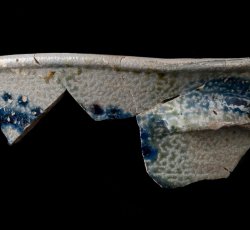 American gray stoneware hollow vessel with lug handle.