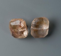 Faceted colorless glass sleeve button pair.
