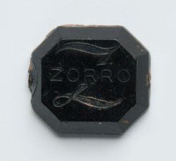 Plastic Zorro ring inlay.