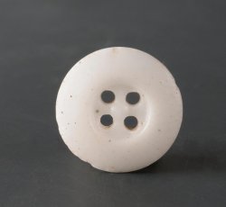 Four-holed porcelain button.