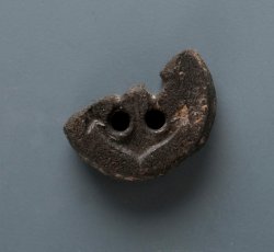 Broken, modern button with ship's anchor.