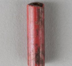 Drawn, compound tubular red bead, long.