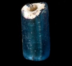 Drawn, simple, tubular blue bead.