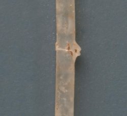 Thin, clear, drawn, simple tubular bead.