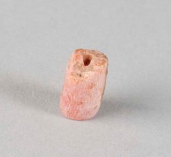 Pink stone tubular bead.