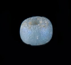 Drawn, simple, sub-spherical, blue bead.