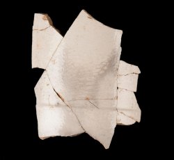 White slip-dipped stoneware mug body.