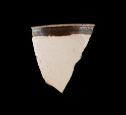 White slip-dipped stoneware mug rim.