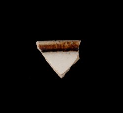 White slip-dipped stoneware mug rim.