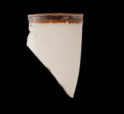 White slip-dipped stoneware mug rim.
