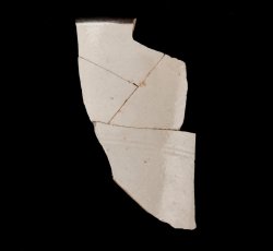 White slip-dipped stoneware mug rim and body.
