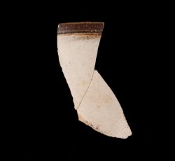 White slip-dipped stoneware mug rim.