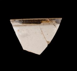 White slip-dipped stoneware mug rim.