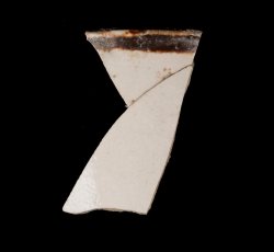White slip-dipped stoneware mug rim and body.