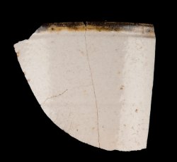 White slip-dipped stoneware mug rim and body.