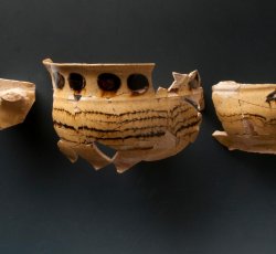 Staffordshire slipware trailed, combed, and dotted drinking pot.