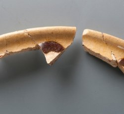 Staffordshire slipware drinking pot.