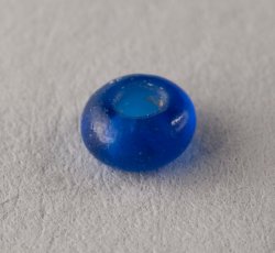 Drawn, simple, sub-spherical, blue bead.