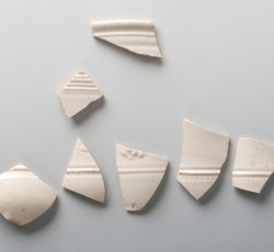 White salt-glazed stoneware hollowware with sprig molding.