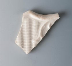 Dot, diaper, and basket molded white salt-glazed stoneware plate.