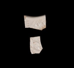 Dot, diaper, and basket molded white salt-glazed stoneware plate.