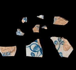 Tin-glazed earthenware hollowware with blue botanical decoration. 