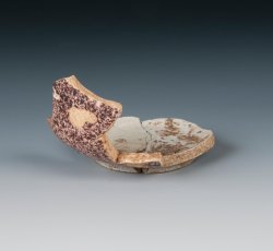 Powdered, manganese tin-glazed earthenware cup. 