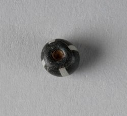 White-striped, black glass bead. 