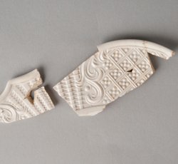 White salt-glazed stoneware dot, diaper, and basket molded plate.
