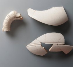 White salt-glazed stoneware teapot with molded sea monster handle.