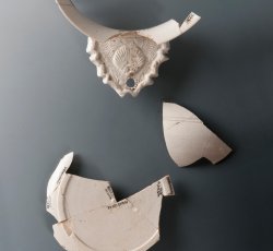 White salt-glazed stoneware porringer with shell-molded handle.